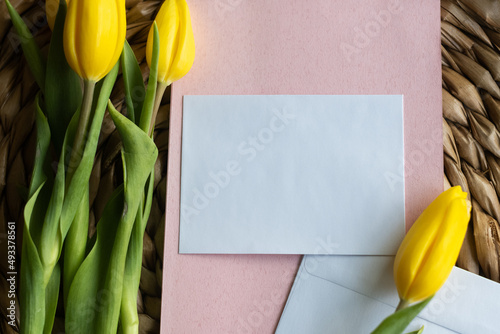 Yellow tulips and pink stationery