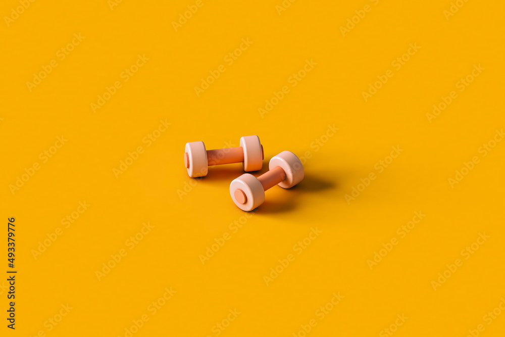 pink dumbbells on an orange. Sports equipment. pink dumbbells on an orange. Sports equipment.