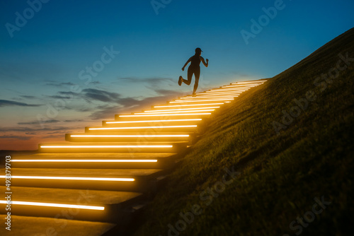 A woman runs outdoors with illumination and sunset