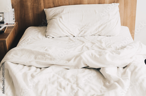 bed made with white linens in the hotel