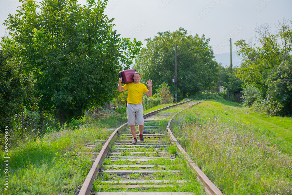 a man carrying a red suitcase on his shoulder a man carrying a red suitcase on his shoulder
