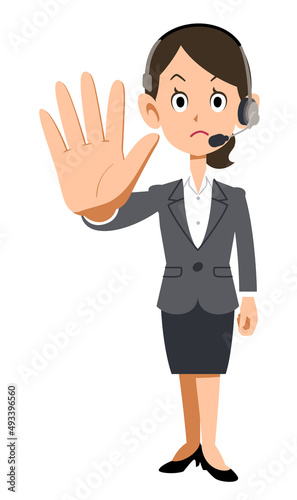 ヘッドセットを装着してスーツを着た女性会社員が制止する
