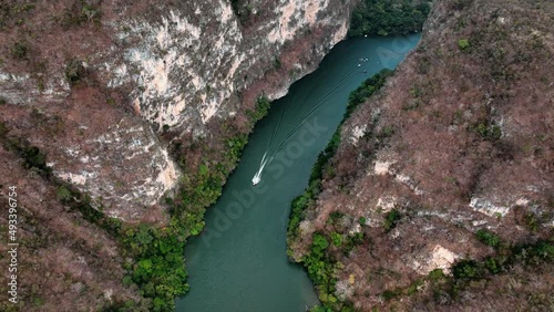 AERIAL - Boat on Grijalva River, Sumidero Canyon, Chiapas, Mexico, reverse tracking shot photo