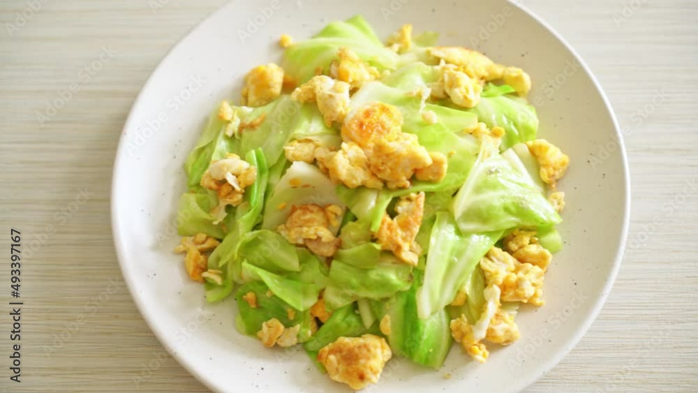 homemade stir-fried cabbage with egg on plate homemade stir-fried cabbage with egg on plate