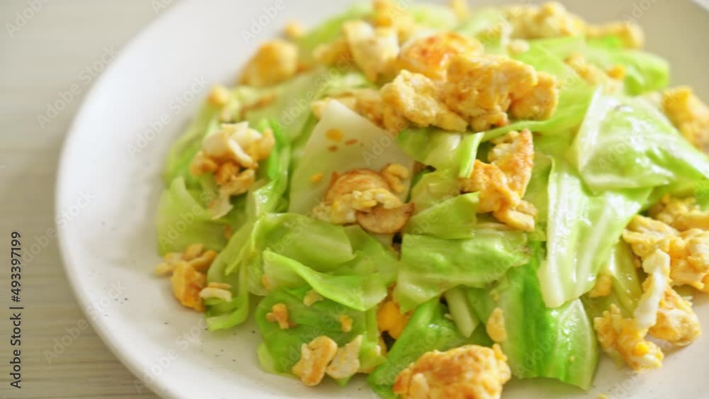 homemade stir-fried cabbage with egg on plate homemade stir-fried cabbage with egg on plate