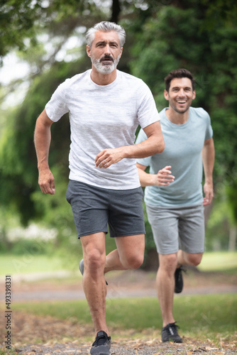 two men jogging in the park