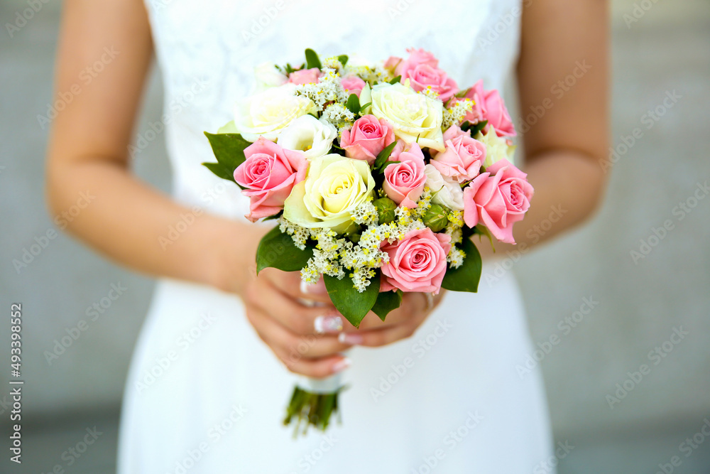 bridal bouquet in the hands of the bride close up with soft focus