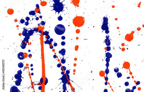 Drops of red and blue paint on a white background.