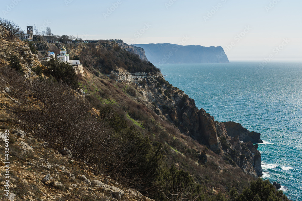 View of Crimean rugged rocky shore with Saint George Monastery in spring. Sevastopol, Crimea