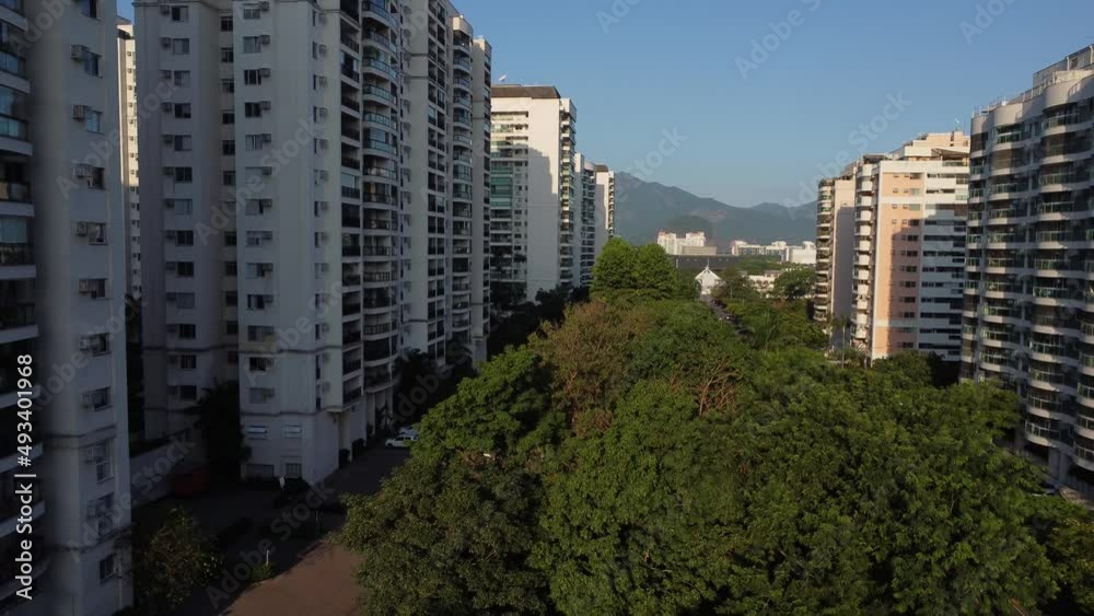 Aerial view of Jacarépagua in Rio de Janeiro, Brazil. Residential buildings and mountains in the background. Rio 2 and Cidade Jardim. Sunny day. Sunset. Drone take. Aerial view of Jacarépagua in Rio de Janeiro, Brazil. Residential buildings and mountains in the background. Rio 2 and Cidade Jardim. Sunny day. Sunset. Drone take.