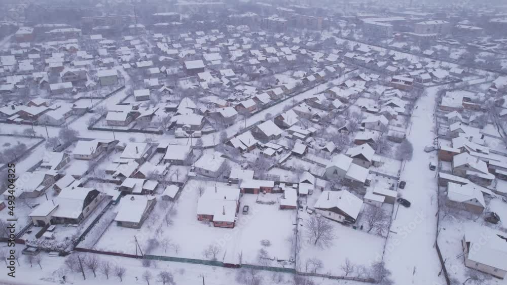 Aerial view of the ukrainian snow village with private houses and garden plots at winter time. Shooting from a drone. Ukraine, Eastern Europe Aerial view of the ukrainian snow village with private houses and garden plots at winter time. Shooting from a drone. Ukraine, Eastern Europe