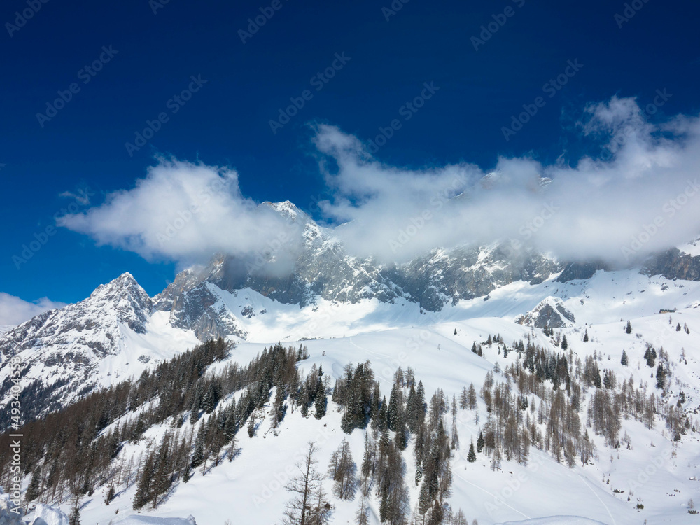 The snowy winter panorama of the Dachstein Alps. The Dachstein is the highest mountain in Upper Austria, Styria. Eternal ice in the Alps. Winter vacation