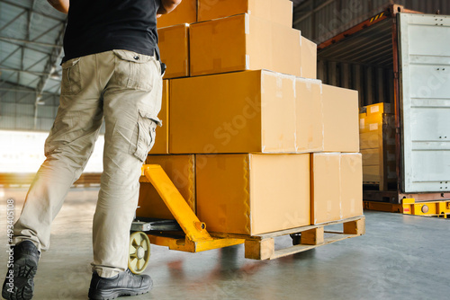 Workers Courier Unloading Packaging Boxes on Pallet into Cargo Container Trucks. Shipping Warehouse. Delivery Service Shipment Boxes. Supply Chain Cargo Transport and Logistics. 