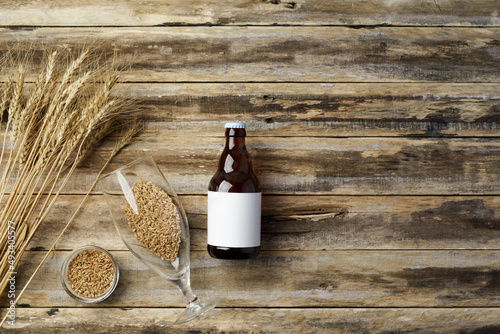 A bottle of beer and grain. Top view. Free space for text.