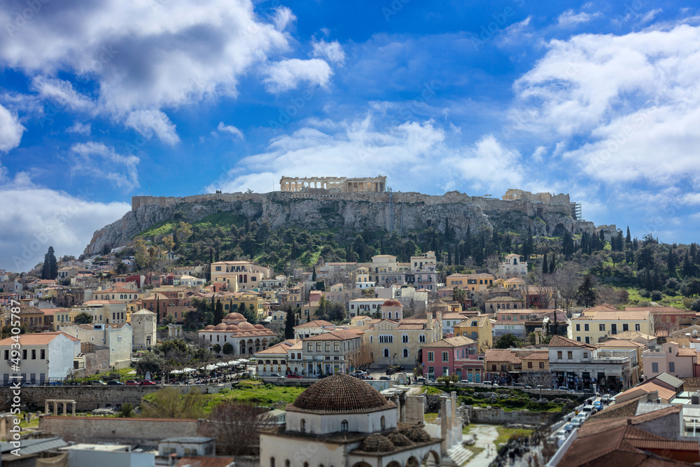 Athens, Greece. Acropolis rock and Monastiraki square, blue sky background, sunny day downtown