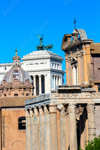 Forum Romanum, view of Temple of Antoninus and Faustina, dome of Santi Luca e Martina church and Victor Emmanuel II Monument, Rome, Italy