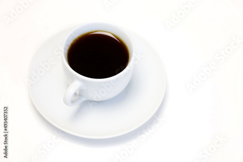 Coffee cup and saucer on a white table, top view © Oleg