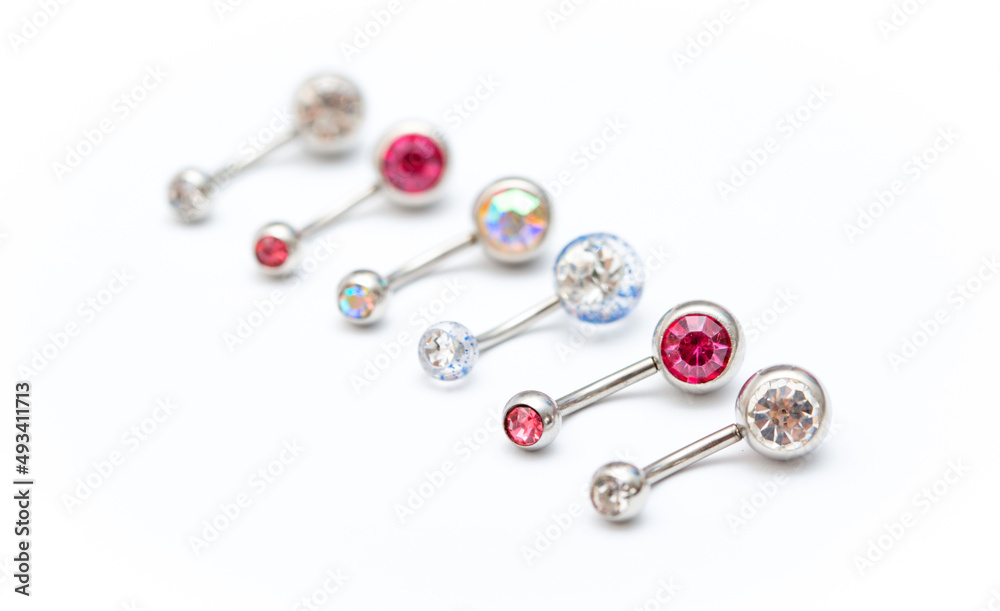 A set of jewelry for piercing on a white background. A set of earrings for the body, nose, navel, tongue, nipples, ears, various beauty jewelry, a set of cosmetological jewelry for piercing. A set of jewelry for piercing on a white background. A set of earrings for the body, nose, navel, tongue, nipples, ears, various beauty jewelry, a set of cosmetological jewelry for piercing.