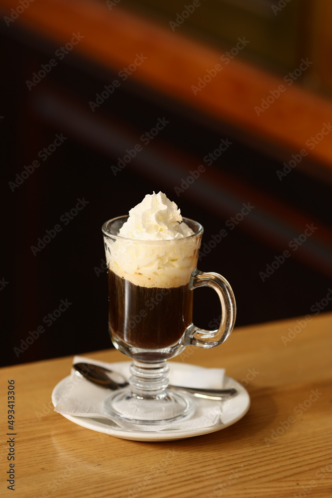 Viennese coffee in a beautiful glass on a plate Viennese coffee in a beautiful glass on a plate