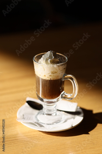 Viennese coffee in a beautiful glass on a plate