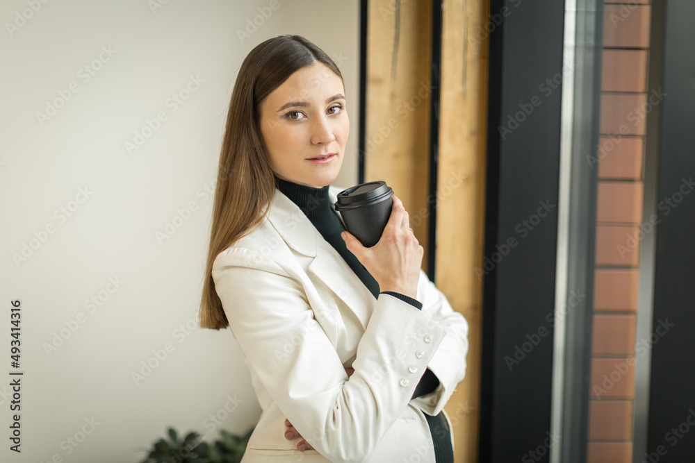 young woman sitting in a cafe at a table