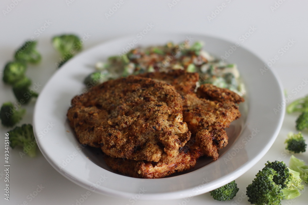 Breaded chicken served with sauteed broccoli in white sauce. Breaded chicken prepared in air fryer