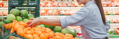 Asian women shopping Healthy food vegetables and fruits in supermarket photo