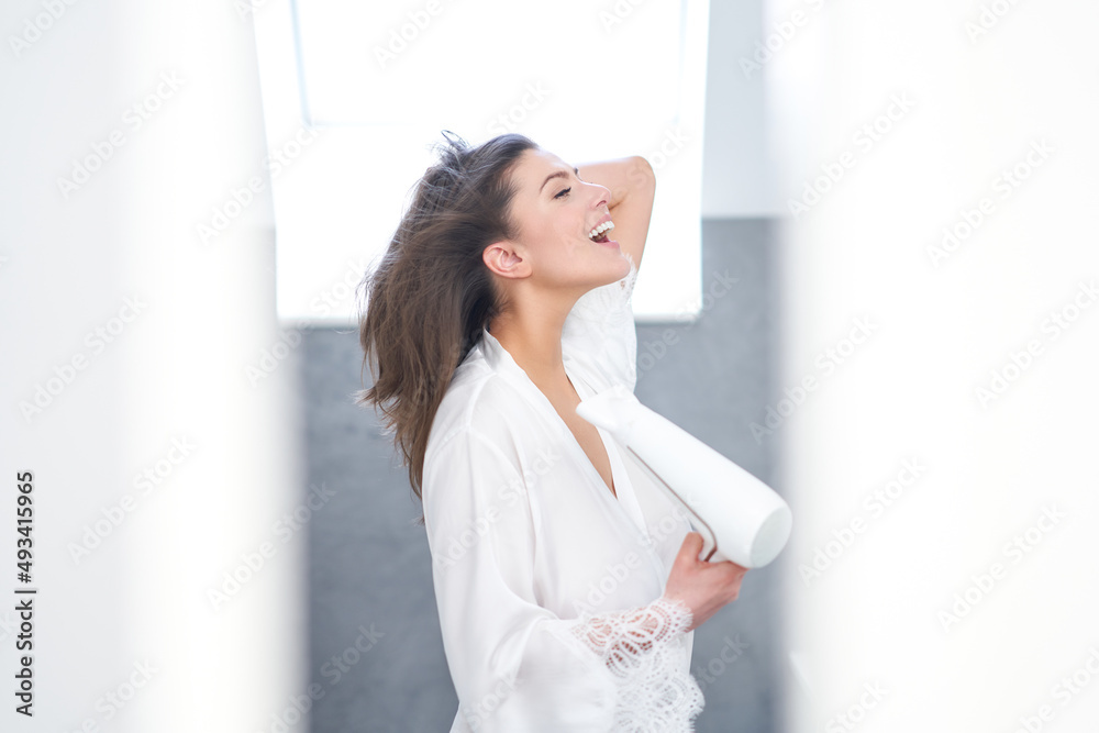 Young nice brunette woman in the bathroom haircare Young nice brunette woman in the bathroom haircare