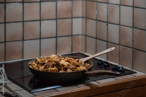 Mashed pancake or Kaiserschmarn in a frying pan in a kitchen. Sw photo