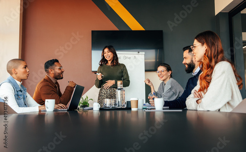 Cheerful businesswoman giving a presentation in a boardroom photo