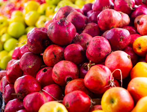 Fresh pomegranate fruits in box on farmers market