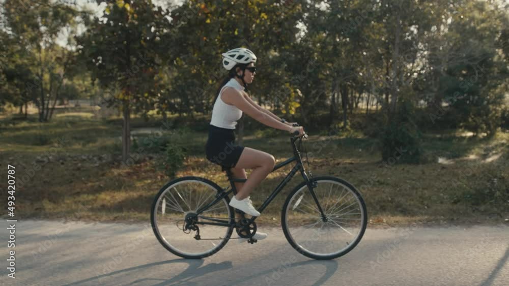 cyclist girl training. Cyclist Woman in Helmet on Bike cyclist girl training. Cyclist Woman in Helmet on Bike