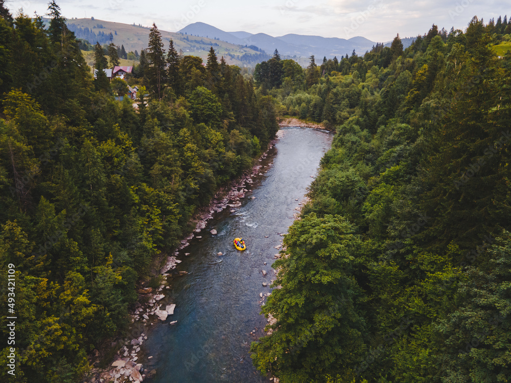 aerial view of mountain river people rafting in creek