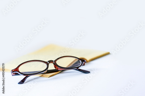 glasses end book on white background