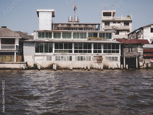 Traditional Thai waterfront old houses, Chao Phraya River, Bangkok, Thailand.