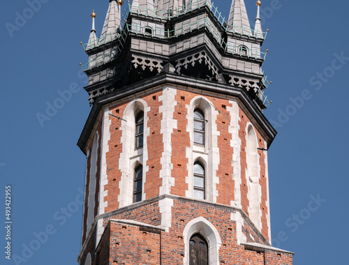 Famous Saint Mary's Basilica (Mariacki Church Kraków) at the Main Market Square in the Old Town district of Krakow, Poland. Close-up of Trumpet Call tower (Hejnał Mariacki).