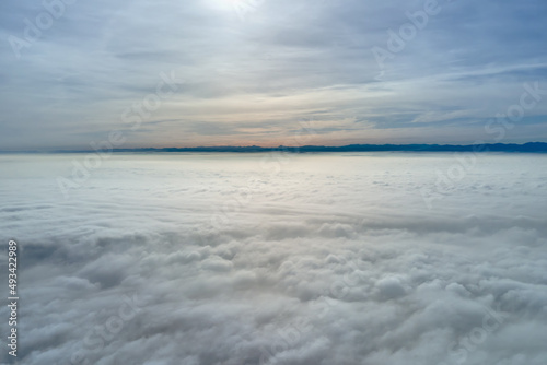 Aerial view from high altitude of earth covered with puffy rainy clouds forming before rainstorm