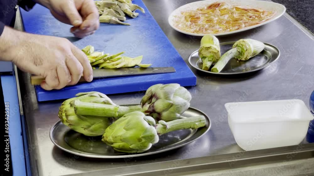 Cutting artichokes in carpaccio slights by professional cook Cutting artichokes in carpaccio slights by professional cook