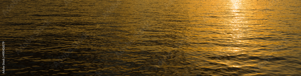 Sunset colors reflected in the water. Water and sea reflection background Sunset colors reflected in the water. Water and sea reflection background