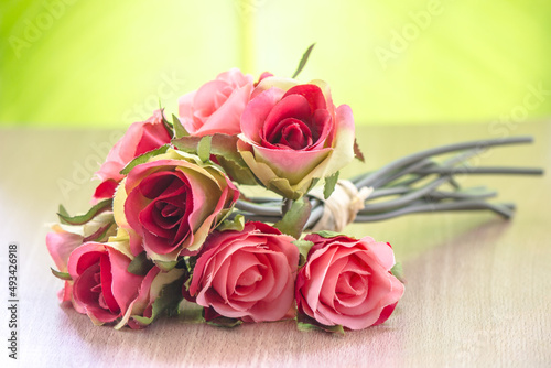 A bouquet of pink roses on the table.
