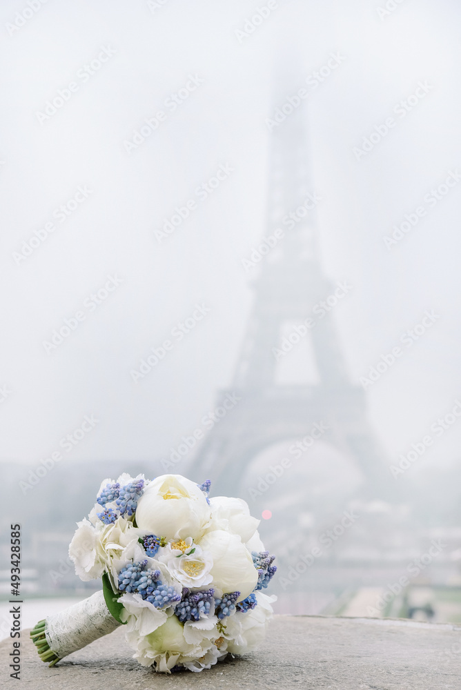 Brautstrauss zur Hochzeit vor der Kulisse des Eifelturms in Paris vertikal