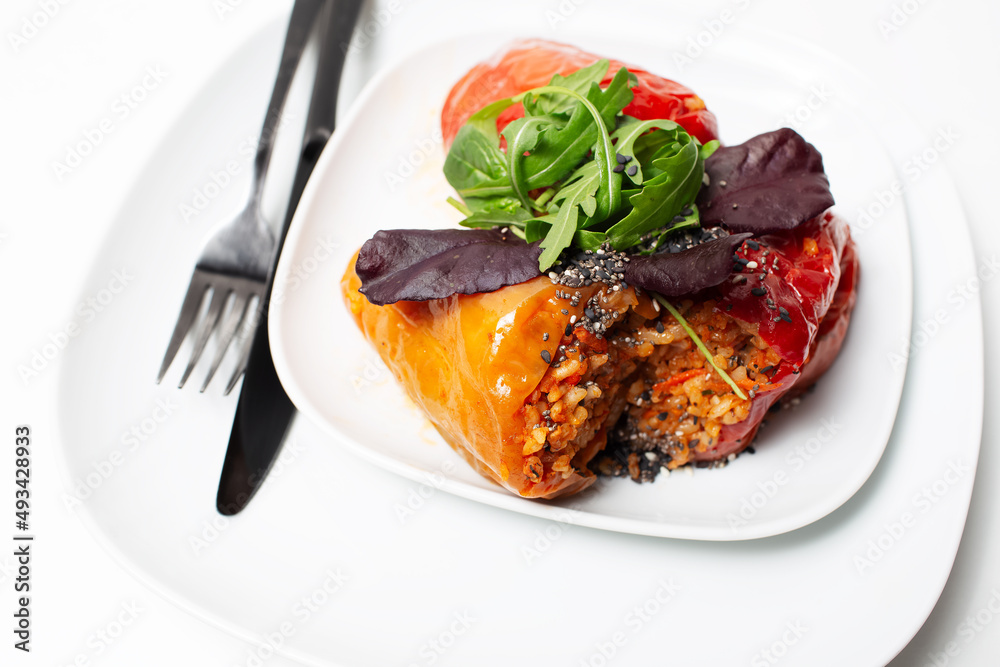 Homemade vegan meal. Stuffed peppers with rice, mushrooms, served with rucola. Homemade vegan meal. Stuffed peppers with rice, mushrooms, served with rucola.