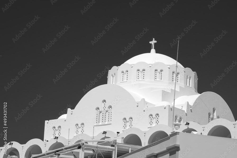 Stunning whitewashed Greek orthodox church and a blue sky in Fira Santorini