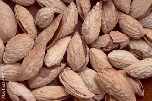 Salted almonds in a shell on a wooden background. Healthy proper nutrition, snack