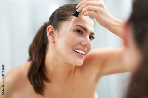 Young nice brunette woman in the bathroom