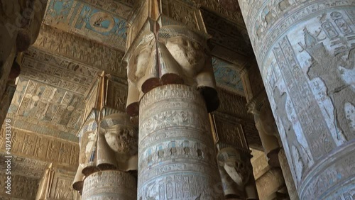 Interior of the painted and carved hypostyle hall at Dendera Temple. Ancient Egyptian temple near Qena. Tilt view 4k photo