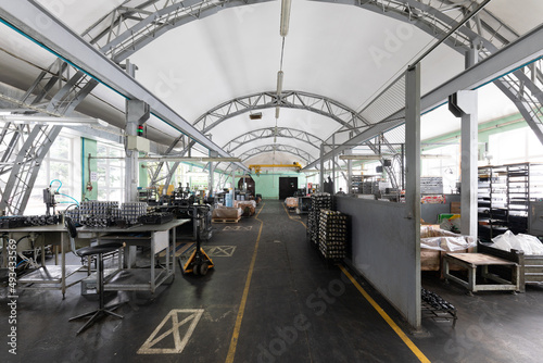 Photo of modern automobile manufacturing workshop. Factory with steel constructions. Plant concept and interior