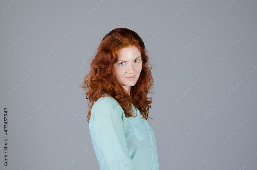 Fototapeta premium Business portrait of beautiful young woman with red curly hair and blue eyes against colorful background. Lifestyle.