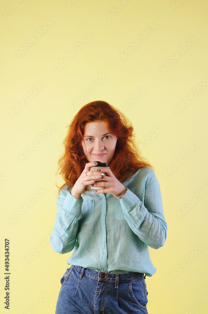 Business portrait of beautiful happy young woman with red curly hair and blue eyes against colorful, gray background. Lifestyle. Business portrait of beautiful happy young woman with red curly hair and blue eyes against colorful, gray background. Lifestyle.