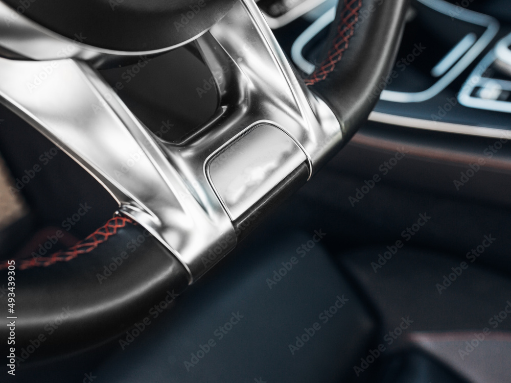 Modern sports car steering wheel close up Modern sports car steering wheel close up